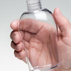 3D vytištěná malá zcela průhledná lahev držená v ruce